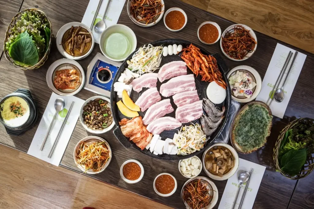 곤지암숯불고기 - 불판에 삼겹살과 대하등 각종음식이 준비된 상차림